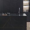 un isla con cascada Xtone Liem Black en una cocina negra