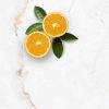 Encimera Arklam Syrac con naranjas cortadas y hojas, superficie resistente a manchas para cocinas en Málaga