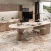 Isla de cocina moderna con encimera Arklam Patagonia Gold en Málaga, diseño orgánico con taburetes.
