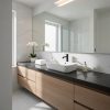 Vanitorio flotante Blaker Negro Sólido negro con lavabo blanco, espejo y gabinetes de madera en baño moderno.