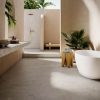 Dormitorio minimalista con piso Venux Bourgogne Perle gris uniforme, cama blanca, manta gris y alfombra redonda en ambiente luminoso con vista natural.